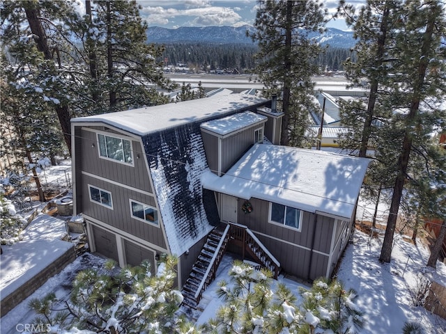 snowy aerial view with a mountain view