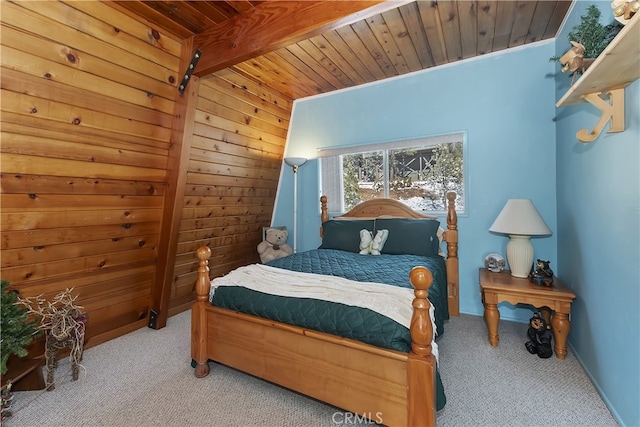 carpeted bedroom featuring beam ceiling and wood ceiling