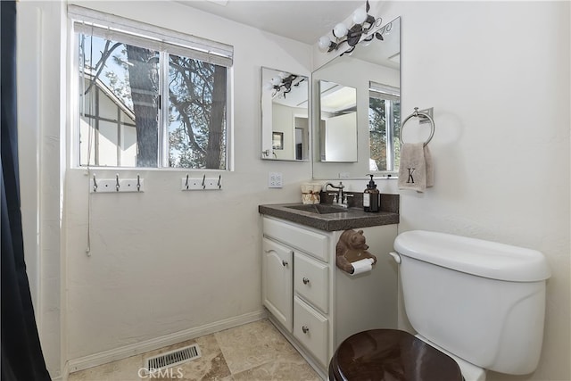 bathroom featuring vanity and toilet