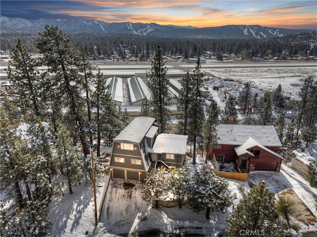 snowy aerial view with a mountain view