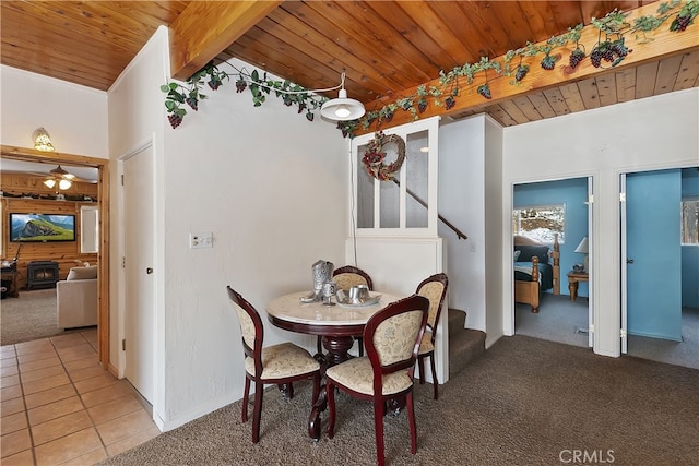 tiled dining area featuring lofted ceiling with beams and wooden ceiling