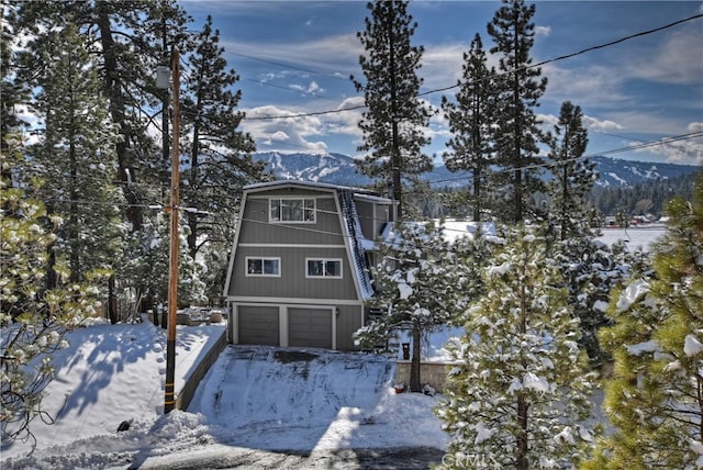 exterior space with a garage and a mountain view