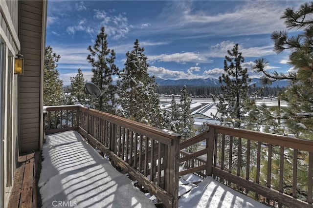 snow covered deck featuring a mountain view