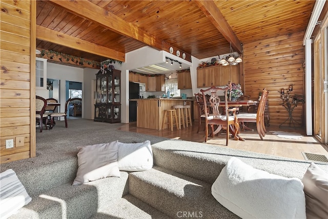 living room featuring hardwood / wood-style flooring, wood ceiling, and beam ceiling