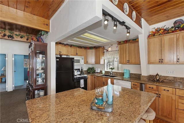 kitchen featuring sink, wood ceiling, light stone counters, a center island, and white appliances