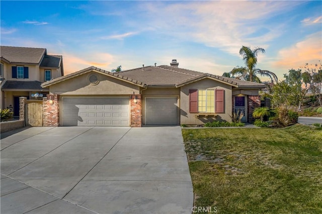 view of front of property with a yard and a garage