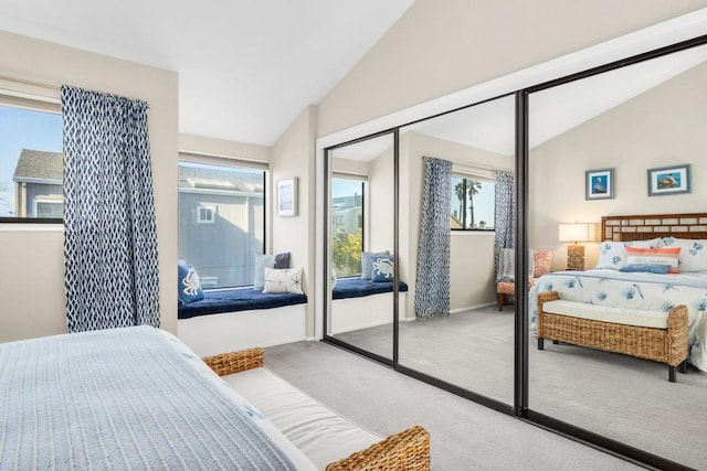 carpeted bedroom featuring vaulted ceiling and a closet