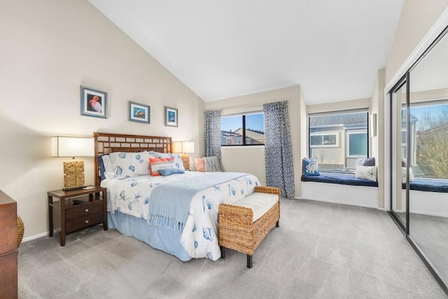 bedroom with high vaulted ceiling, a closet, and carpet