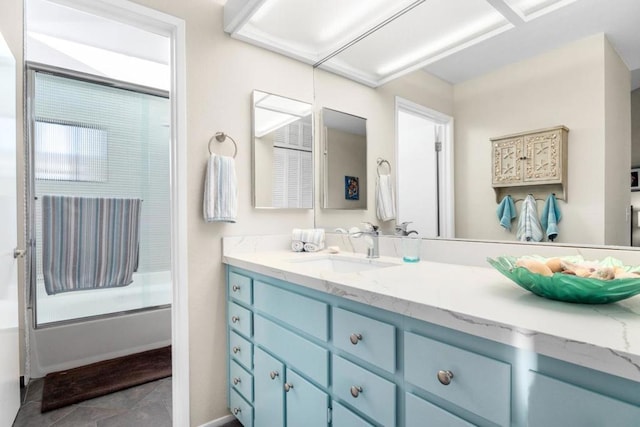 bathroom with vanity and bath / shower combo with glass door