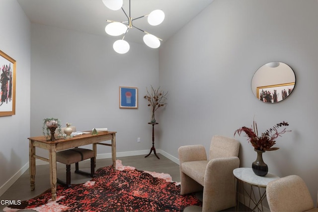 office with light wood-type flooring and an inviting chandelier