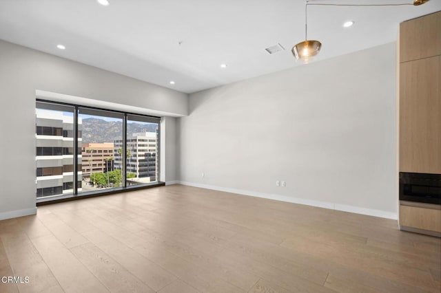 unfurnished living room with light hardwood / wood-style flooring