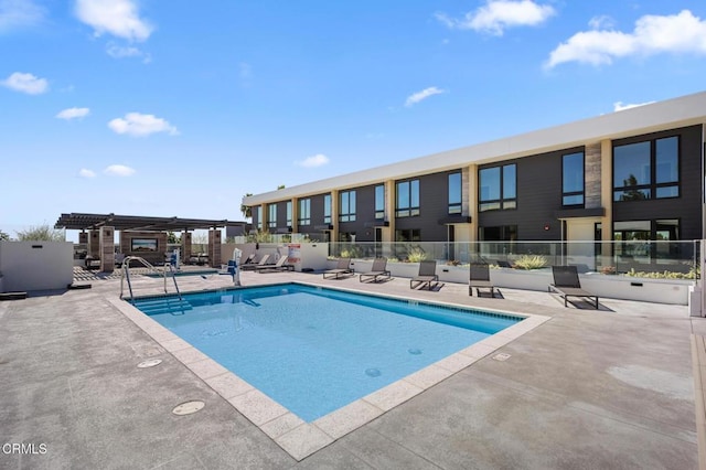 view of pool with a pergola and a patio