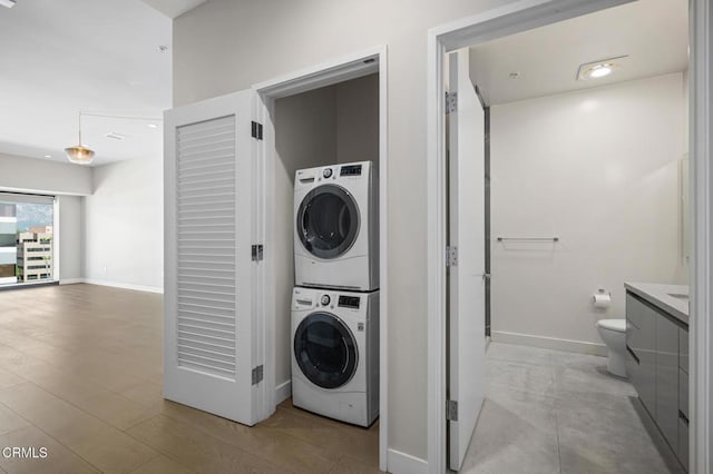 washroom featuring stacked washer / drying machine and light hardwood / wood-style floors