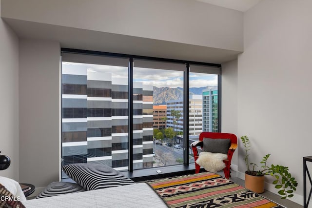 bedroom featuring a mountain view and a wall of windows