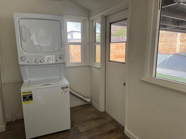 laundry room featuring stacked washer and dryer and dark hardwood / wood-style floors