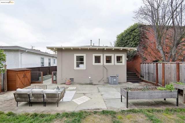 rear view of property with an outdoor living space, a patio, and cooling unit