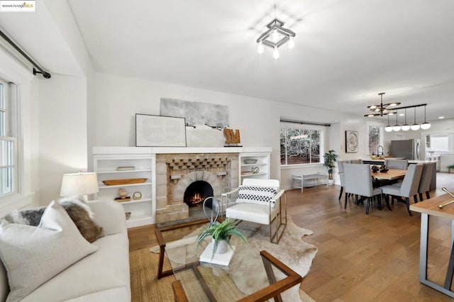 living room featuring wood-type flooring and a notable chandelier