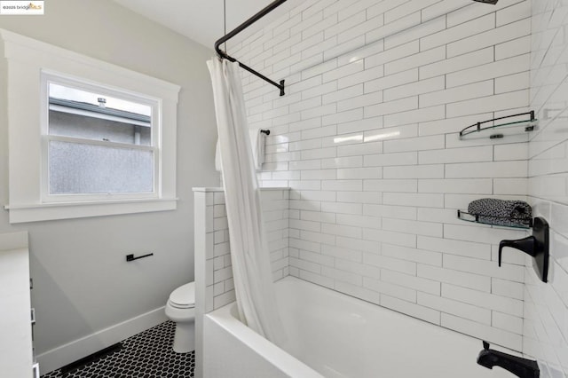 bathroom featuring shower / bath combo and toilet