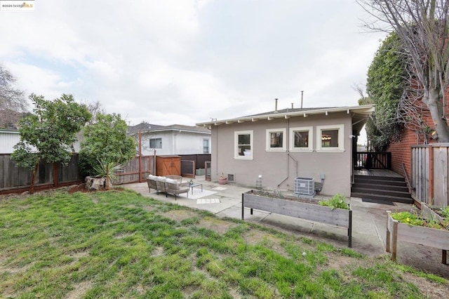 rear view of property with a yard, an outdoor hangout area, a patio area, and central air condition unit