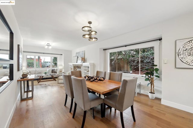 dining room featuring light hardwood / wood-style flooring and a notable chandelier