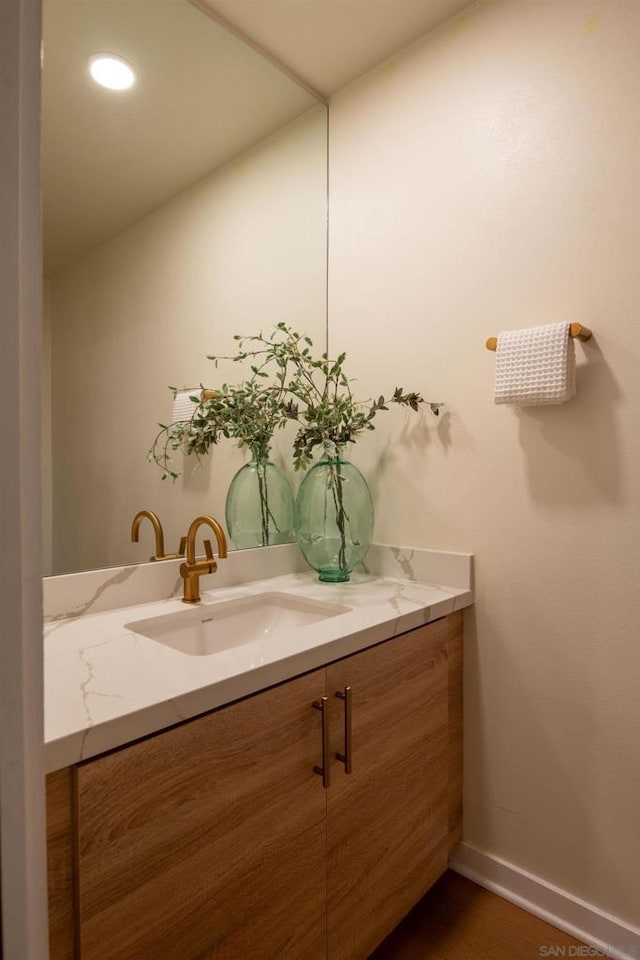 bathroom with vanity and wood-type flooring