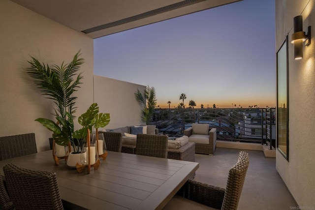 balcony at dusk with an outdoor hangout area