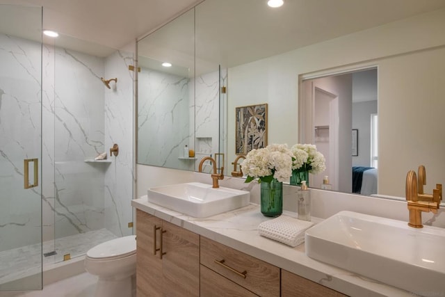 bathroom with vanity, toilet, and a shower with shower door