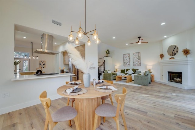 dining room with light hardwood / wood-style floors and ceiling fan