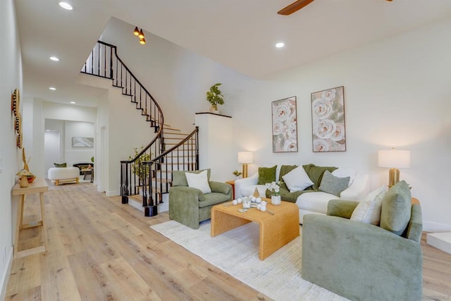 living room with ceiling fan and light wood-type flooring