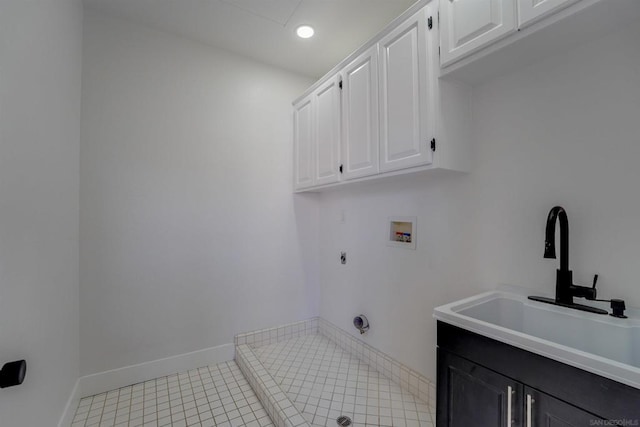 clothes washing area featuring sink, electric dryer hookup, cabinets, washer hookup, and light tile patterned flooring