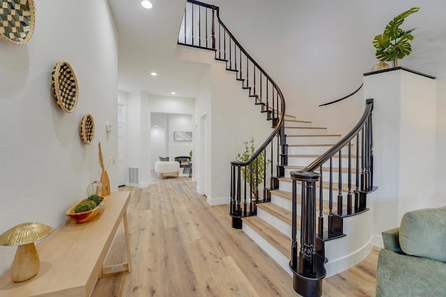 foyer with a high ceiling and light wood-type flooring