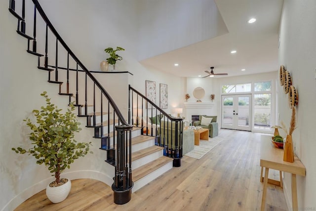 entryway with french doors, ceiling fan, and wood-type flooring