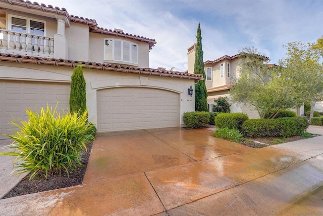 mediterranean / spanish-style home with a garage and a balcony