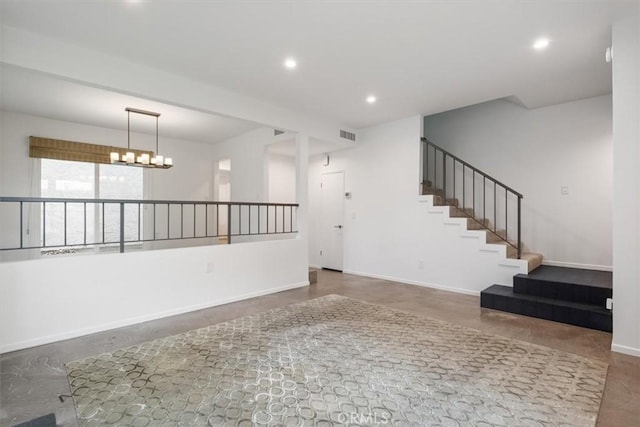 unfurnished living room with a notable chandelier