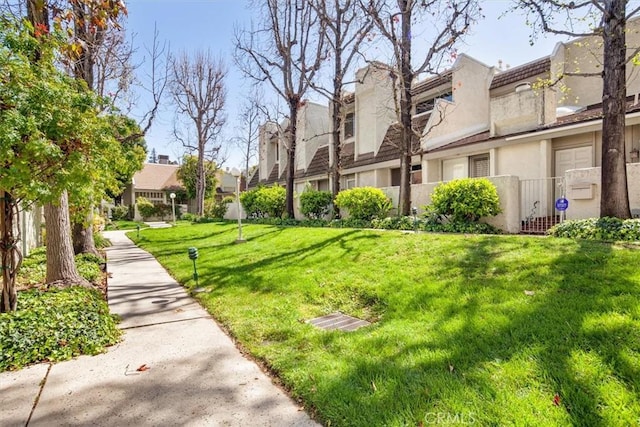 view of home's community featuring a lawn