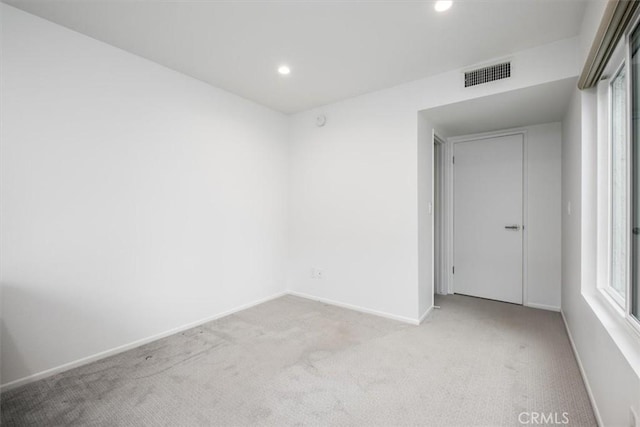 unfurnished room with light colored carpet