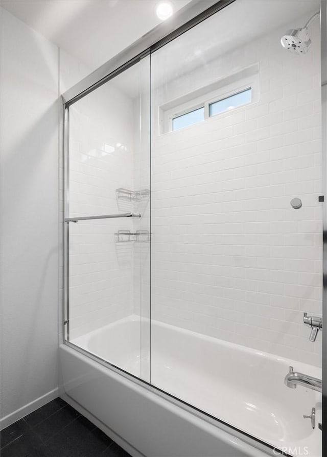 bathroom with tile patterned flooring and combined bath / shower with glass door