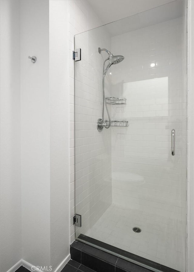 bathroom with a shower with door