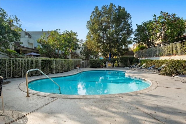 view of swimming pool featuring a patio area