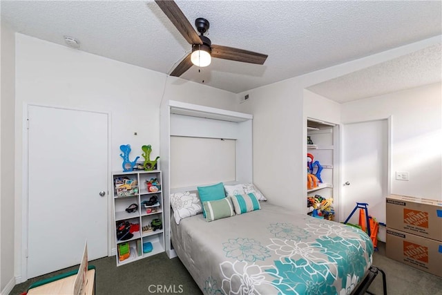 bedroom featuring ceiling fan, a closet, a textured ceiling, and carpet