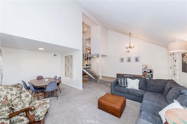 carpeted living room with high vaulted ceiling and a notable chandelier