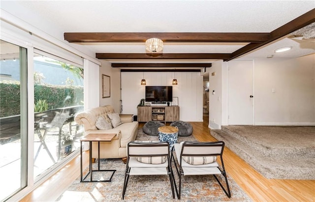 living room with beam ceiling and hardwood / wood-style floors