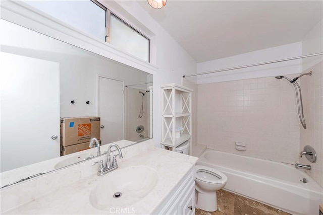 full bathroom with tiled shower / bath, vanity, and toilet