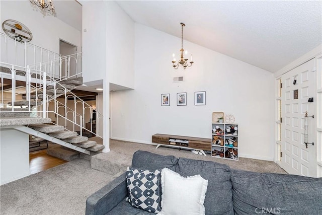 carpeted living room with high vaulted ceiling and a notable chandelier