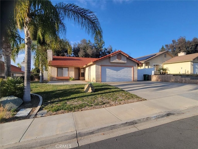 ranch-style home featuring a garage and a front yard