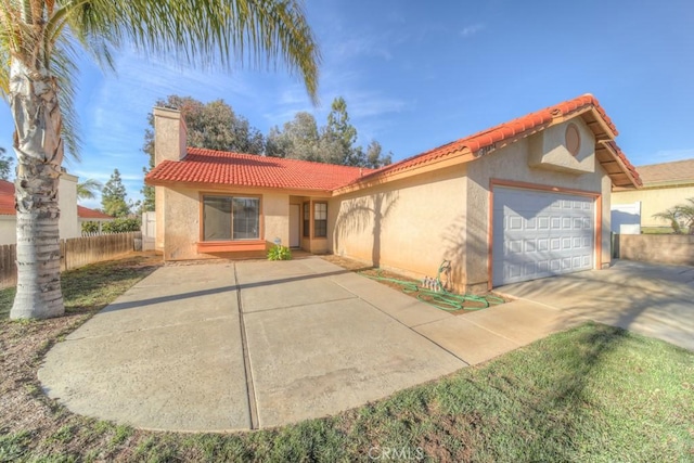 mediterranean / spanish-style house with a garage