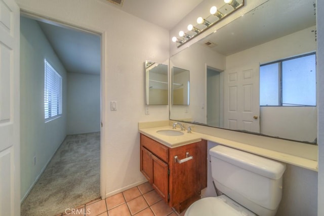 bathroom with vanity, tile patterned flooring, and toilet