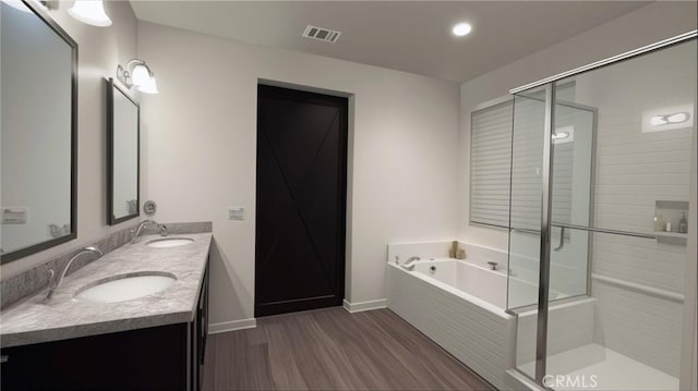 bathroom with vanity, hardwood / wood-style floors, and independent shower and bath