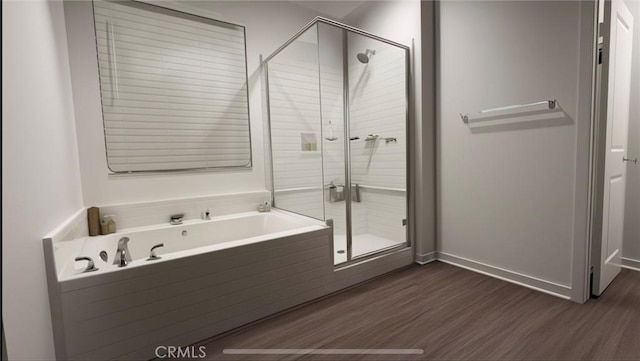 bathroom featuring hardwood / wood-style flooring and independent shower and bath