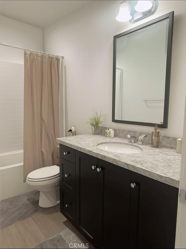 full bathroom featuring vanity, toilet, and shower / tub combo